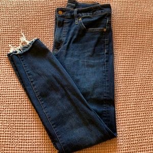 Dark wash skinny jeans with frayed hem